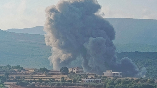 Smoke billows from the site of an Israeli airstrike on Zibqin in southern Lebanon on August 25, 2024, amid escalations in the ongoing cross-border tensions as fighting continues between Israel and Hamas militants in the Gaza Strip. Hezbollah said early on August 25 it had launched more than 320 rockets at Israel overnight, targeting a string of military positions, even as Israel's military said it was carrying out pre-emptive strikes against the group. (Photo by Kawnat HAJU / AFP)