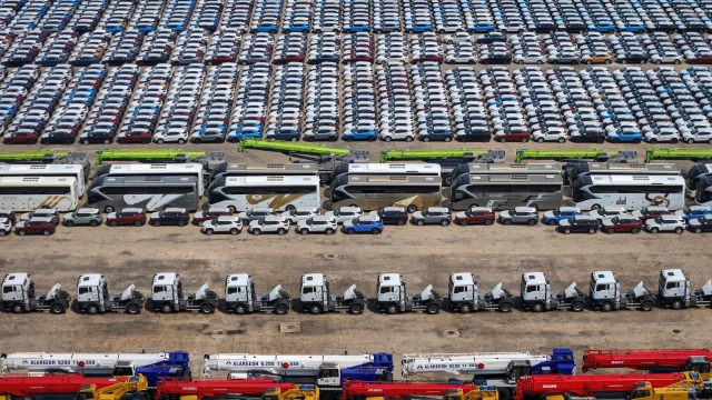 This photo taken on May 8, 2024 shows vehicles for export waiting to be loaded onto a ship at Yantai Port in Yantai, in China's eastern Shandong Province. (Photo by AFP) / China OUT