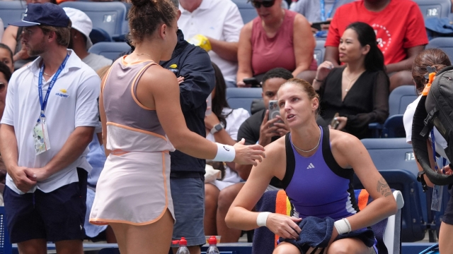 Czech Republic's Karolina Pliskova (R) speak with Italy's Jasmine Paolini while retiring from her women's singles second round tennis match with an injured foot on day four of the US Open tennis tournament at the USTA Billie Jean King National Tennis Center in New York City, on August 29, 2024. (Photo by TIMOTHY A. CLARY / AFP)