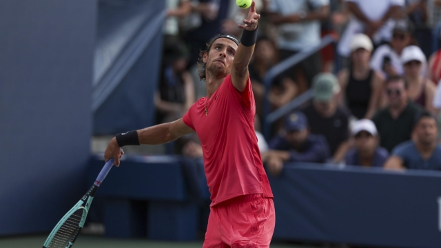 epa11570255 Lorenzo Musetti of Italy in action against Miomir Kecmanovic of Serbia (unseen) during their second round match of the US Open Tennis Championships at the USTA Billie Jean King National Tennis Center in Flushing Meadows, New York, USA, 28 August 2024. The US Open tournament runs from 26 August through 08 September.  EPA/SARAH YENESEL