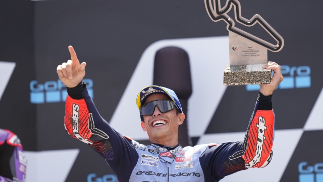 Spain's rider Marc Marquez of the Gresini Racing MotoGP celebrates with the trophy after winning the MotoGP race during the Aragon Motorcycle Grand Prix at the MotorLand Aragon circuit, in Alcaniz, Spain, Sunday, Sept. 1, 2024. (AP Photo/Jose Breton)