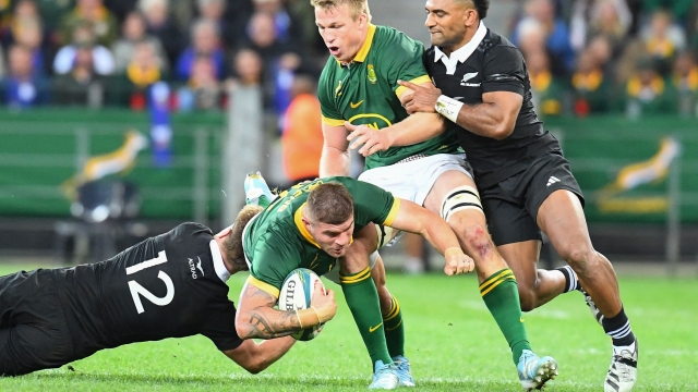 New Zealand's centre Jordie Barrett (L) tackles South Africa's hooker Malcolm Marx (2nd L) during the Rugby Championship Test match between South Africa and New Zealand at the Cape Town Stadium in Cape Town on September 7, 2024. (Photo by Rodger Bosch / AFP)