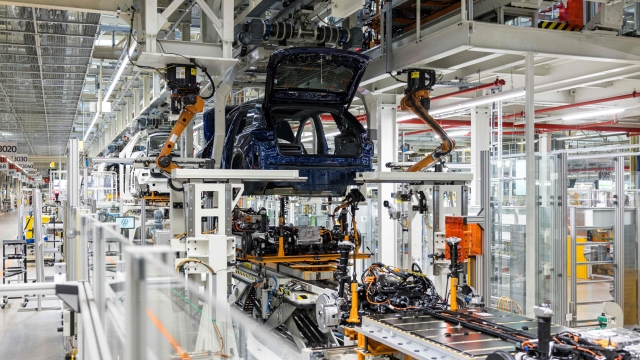 An electric car is manufactured at the production plant of German car manufacturer Volkswagen in Zwickau, eastern Germany, on August 20, 2024. In Zwickau, the automotive cradle of the former GDR, multiple crises are fuelling the influence of the extreme right, as is the case almost everywhere in Saxony before the regional elections on September 1. (Photo by JENS SCHLUETER / AFP)