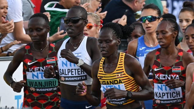 (FILES) (From L to R) Kenya's Rosemary Wanjiru, Israel's Lonah Chemtai Salpeter, Uganda's Rebecca Cheptegei and Kenya's Selly Chepyego Kaptich compete in the women's marathon final during the World Athletics Championships in Budapest on August 26, 2023. A Ugandan marathoner who competed at the Paris Olympics is in intensive care after  being set on fire alledgedly by her partner in Kenya, officials said on September 3, 2024, the latest horrific incident of gender-based violence in the East African country. Long-distance runner Rebecca Cheptegei, 33, was assaulted after her Kenyan partner Dickson Ndiema Marangach reportedly snuck into her home in western Trans-Nzoia county on September 1, 2024 at around 2:00 pm while she and her children were at church, police said. (Photo by Ferenc ISZA / AFP)