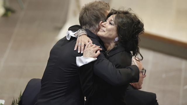 David Beckham and Nancy Dell'Olio hug as they arrive to attend the funeral service of Swedish soccer manager Sven-Goran Eriksson at Fryksände church in Torsby, Sweden, Friday Sept. 13, 2024. (Adam Ihse/TT News Agency via AP)