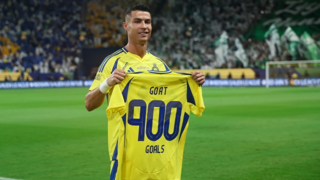 RIYADH, SAUDI ARABIA - SEPTEMBER 13: Cristiano Ronaldo of Al Nassr holds 900 goals t-shirt before the Saudi Pro League match between Al Nassr FC v Al-Ahli Saudi FC at Al-Awwal Stadium on September 13, 2024 in Riyadh, Saudi Arabia. (Photo by Yasser Bakhsh/Getty Images)