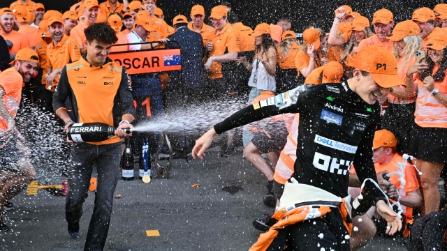 McLaren's Australian driver Oscar Piastri celebrates with the team after winning the Formula One Azerbaijan Grand Prix at the Baku City Circuit in Baku on September 15, 2024. (Photo by Andrej ISAKOVIC / AFP)