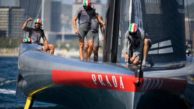 Italy's Luna Rossa Prada Pirelli team members celebrate after winning on the fifth day of the 37th America's Cup-Luis Vuitton semi-finals race, off the coast of Barcelona on September 19, 2024. (Photo by Josep LAGO / AFP)