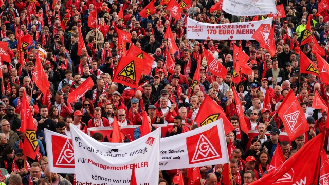 Members of the IG Metall metalworkers union demonstrate on September 25, 2024 in Hanover, northern Germany, where talks between unions and the Volkswagen management are taking place following an announcement of German carmaker Volkswagen (VW) that drastic cost-cutting measures are needed to keep the carmaker competitive. After Volkswagen's bombshell announcement earlier in September 2024 that it could close factories in Germany for the first time, company management and unions will begin tense talks on a new pay deal. Volkswagen has repeatedly stressed that its costs are excessive and profit margins too low, particularly at its core VW brand. (Photo by RONNY HARTMANN / AFP)