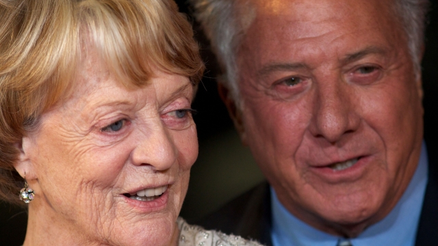 (FILES) US actor and director Dustin Hoffman (R) poses with British actress Maggie Smith (L) on the red carpet as they arrive to attend the premiere of 'Quartet' during the 56th BFI London Film Festival in London on October 15, 2012. Oscar-winning British actor Maggie Smith, a star of stage and screen for more than seven decades, died in hospital in London on Friday, September 27, her sons announced. (Photo by ANDREW COWIE / AFP)