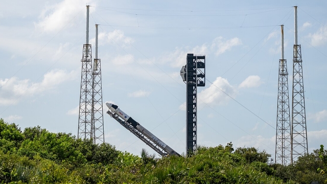 A SpaceX Falcon 9 rocket with the company's Dragon spacecraft on top is seen as it is raised into a vertical position on the launch pad at Space Launch Complex 40 as preparations continue for the Crew-9 mission, Friday, Sept. 27, 2024, at Cape Canaveral Space Force Station in Florida. NASA’s SpaceX Crew-9 mission is the ninth crew rotation mission of the SpaceX Dragon spacecraft and Falcon 9 rocket to the International Space Station as part of the agency’s Commercial Crew Program. NASA astronaut Nick Hague and Roscosmos cosmonaut Aleksandr Gorbunov are scheduled to launch on 1:17 p.m. EDT on Saturday, Sept. 28, from Space Launch Complex 40 at the Cape Canaveral Space Force Station. Photo Credit: (NASA/Keegan Barber)