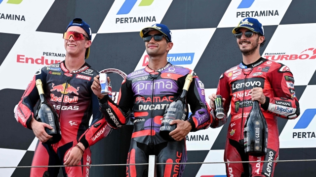 (L to R) Second-placed RedBull GASGAS Tech3's Spanish rider Pedro Acosta, first-placed Prima Pramac Racing's Spanish rider Jorge Martin and third-placed Ducati Lenovo Team's Italian rider Francesco Bagnaia celebrate on the podium following the MotoGP race of the Indonesian Grand Prix at the Mandalika International Circuit in Mandalika, West Nusa Tenggara on September 29, 2024. (Photo by SONNY TUMBELAKA / AFP)