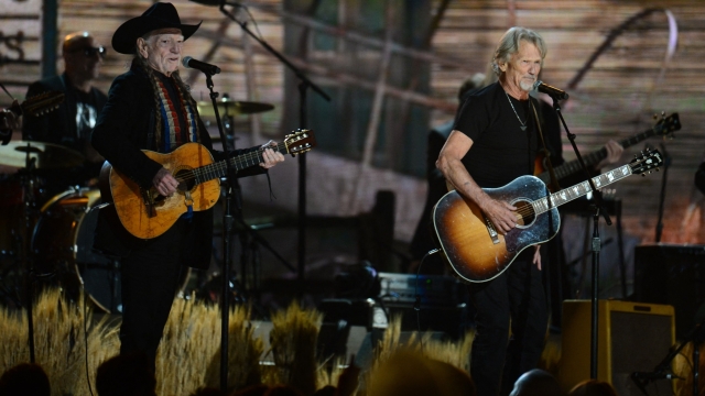 (FILES) Willie Nelson (L) and Kris Kristofferson perform on stage during the 56th Grammy Awards at the Staples Center in Los Angeles, California, January 26, 2014. US singer-songwriter Kris Kristofferson, a country music legend who notably hit the silver screen opposite Barbra Streisand in "A Star is Born," has died at the age of 88, his family announced Sunday. (Photo by Frederic J. BROWN / AFP)