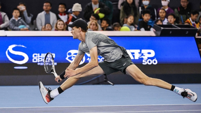 Italy's Jannik Sinner jumps for a return to Czech Republic's Jiri Lehecka during their men's singles quarter-final match at the China Open tennis tournament in Beijing on September 30, 2024. (Photo by GREG BAKER / AFP)