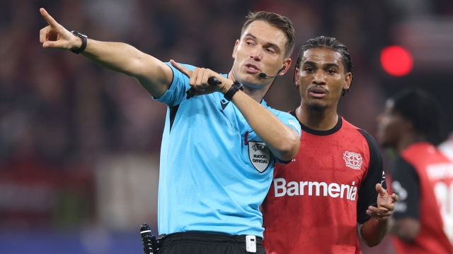 LEVERKUSEN, GERMANY - OCTOBER 01: Referee Sandro Scharer gestures during the UEFA Champions League 2024/25 League Phase MD2 match between Bayer 04 Leverkusen and AC Milan at BayArena on October 01, 2024 in Leverkusen, Germany. (Photo by Lars Baron/Getty Images)