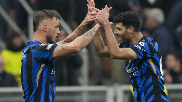 Inter Milan's Marko Arnautovic, left, celebrates with Inter Milan's Mehdi Taremi after scoring his side's second goal during the Champions League opening phase soccer match between Inter Milan and Red Star, at the San Siro stadium in Milan, Italy, Tuesday, Oct. 1, 2024. (AP Photo/Luca Bruno)