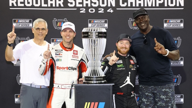 DARLINGTON, SOUTH CAROLINA - SEPTEMBER 01: 2024 Regular Season Champion, Tyler Reddick, driver of the #45 Upper Deck Toyota, poses with 23XI Racing co-owners NBA Hall of Famer, Michael Jordan and Denny Hamlin, driver of the #11 Sport Clips Haircuts Toyota, after the NASCAR Cup Series Cook Out Southern 500 at Darlington Raceway on September 01, 2024 in Darlington, South Carolina.   Meg Oliphant/Getty Images/AFP (Photo by Meg Oliphant / GETTY IMAGES NORTH AMERICA / Getty Images via AFP)