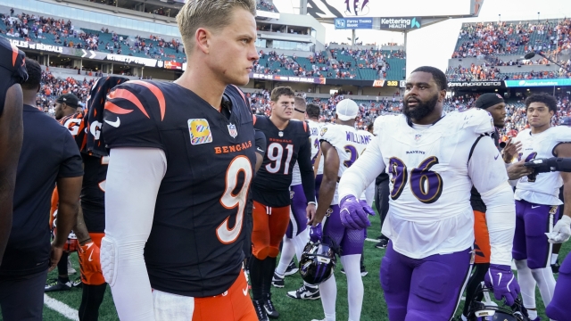 Cincinnati Bengals quarterback Joe Burrow, left, walks near Baltimore Ravens defensive tackle Broderick Washington following an NFL football game, Sunday, Oct. 6, 2024, in Cincinnati. The Ravens won 41-38 in overtime. (AP Photo/Jeff Dean)