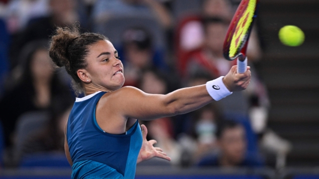 Italy's Jasmine Paolini hits a return to China's Yuan Yue during women's singles match at the Wuhan Open tennis tournament in Wuhan, China's Hubei province on October 9, 2024. (Photo by WANG Zhao / AFP)