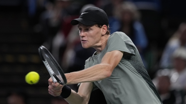 Jannik Sinner of Italy returns a shot against Novak Djokovic of Serbia during the men's singles finals match in the Shanghai Masters tennis tournament at Qizhong Forest Sports City Tennis Center in Shanghai, China, Sunday, Oct. 13, 2024. (AP Photo/Andy Wong)