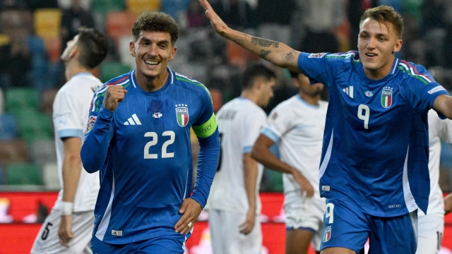 Italy's defender #22 Giovanni Di Lorenzo (L) celebrates scoring his team's second goal nxto Italy's forward #09 Mateo Retegui (R) during the UEFA Nations League, Ligue A Group A2 football match between Italy and Israel at the Friuli stadium in Udine, on October 14, 2024. (Photo by Tiziana FABI / AFP)