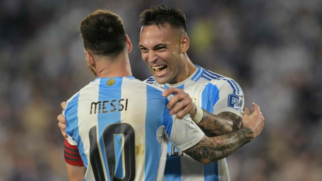 Argentina's forward #22 Lautaro Martinez celebrates with Argentina's forward #10 Lionel Messiafter scoring during the 2026 FIFA World Cup South American qualifiers football match between Argentina and Bolivia at the Mas Monumental stadium in Buenos Aires on October 15, 2024. (Photo by JUAN MABROMATA / AFP)