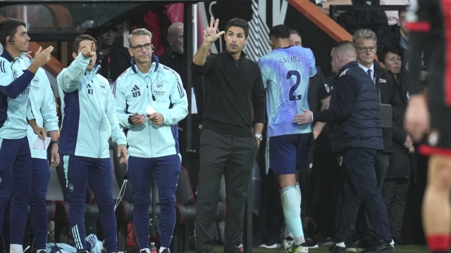 Arsenal's manager Mikel Arteta gives instructions from the side line as Arsenal's William Saliba, centre right, leaves the pitch after receiving the red card during the English Premier League soccer match between Bournemouth and Arsenal at the Vitality Stadium in Bournemouth, England, Saturday, Oct. 19, 2024. (AP Photo/Kin Cheung)