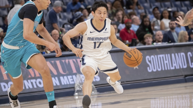 Memphis Grizzlies guard Yuki Kawamura (17), of Japan, dribbles while defended by Charlotte Hornets' Tidjane Salaun, left, of France, in the second half of a preseason NBA basketball game Thursday, Oct. 10, 2024, in Memphis, Tenn. (AP Photo/Nikki Boertman)