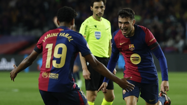 Barcelona's Pedri, right, celebrates with Barcelona's Lamine Yamal after scoring his side's second goal during a Spanish La Liga soccer match between Barcelona and Sevilla at the Olimpic Lluis Companys stadium in Barcelona, Spain, Sunday, Oct. 20, 2024. (AP Photo/Joan Monfort)