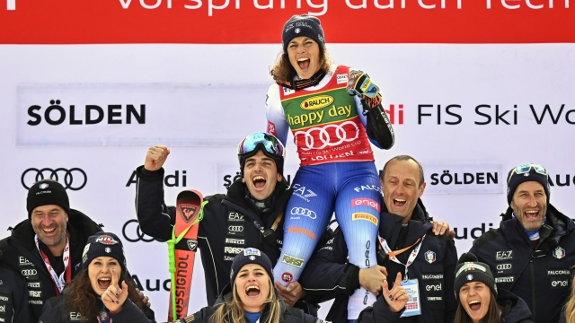 epa11684735 The Winner Federica Brignone of Italy celebrates with her team during the podium ceremony for the Women's Giant Slalom race at the FIS Alpine Skiing World Cup season opener on the Rettenbach glacier, in Soelden, Austria, 26 October 2024.  EPA/JEAN-CHRISTOPHE BOTT