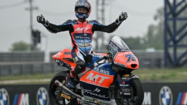 TOPSHOT - MT Helmets - MSI's Japanese rider Ai Ogura celebrates winning the Moto2 Championship after the Moto2 class race of the MotoGP Thailand Grand Prix at the Buriram International Circuit in Buriram on October 27, 2024. (Photo by Lillian SUWANRUMPHA / AFP)