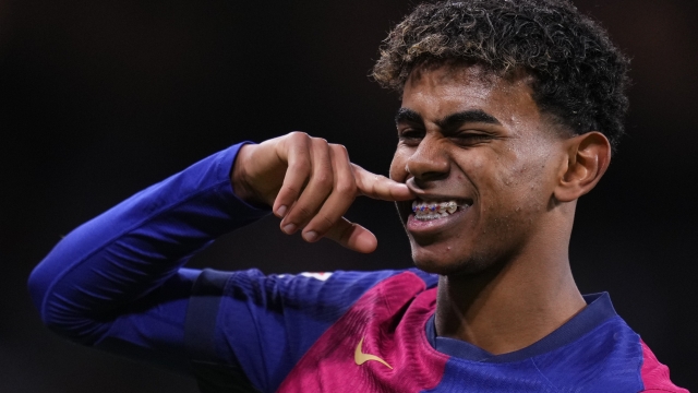 Barcelona's Lamine Yamal celebrates after scoring his side's third goal during a Spanish La Liga soccer match between Real Madrid and Barcelona at the Santiago Bernabeu stadium in Madrid, Spain, Saturday, Oct. 26, 2024. (AP Photo/Manu Fernandez)