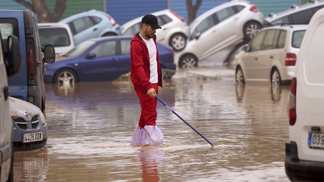 A man walks through flooded streets in Valencia, Spain, Wednesday, Oct. 30, 2024. (AP Photo/Alberto Saiz)