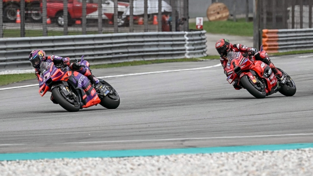 Prima Pramac Racing's Spanish rider Jorge Martin (L) rides in front of Ducati Lenovo Team's Italian rider Francesco Bagnaia in the Sprint race of the MotoGP Malaysian Grand Prix at the Sepang International Circuit in Sepang on November 2, 2024. (Photo by Lillian SUWANRUMPHA / AFP)