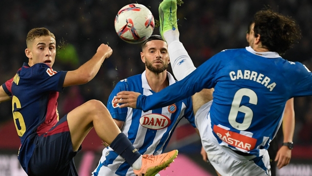 Barcelona's Spanish midfielder #16 Fermin Lopez (L) is challenged by  Espanyol's Uruguayan defender #06 Leandro Cabrera during the Spanish league football match between FC Barcelona and RCD Espanyol at the Estadi Olimpic Lluis Companys in Barcelona, on November 3, 2024. (Photo by Josep LAGO / AFP)