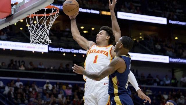 Atlanta Hawks forward Jalen Johnson (1) dunks against New Orleans Pelicans forward Jamal Cain (8) during the second half of an NBA basketball game in New Orleans, Sunday, Nov. 3, 2024. (AP Photo/Matthew Hinton)