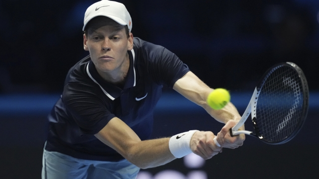 Italy\'s Jannik Sinner returns the ball to Australia\'s Alex de Minaur during their singles tennis match of the ATP World Tour Finals at the Inalpi Arena, in Turin, Italy, Sunday, Nov. 10, 2024. (AP Photo/Antonio Calanni)