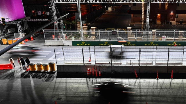 Pedestrians wait to cross a street along the race track ahead of the Las Vegas Formula 1 Grand Prix on November 20, 2024 in Las Vegas, Nevada. (Photo by Patrick T. Fallon / AFP)