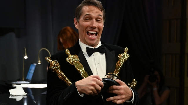 TOPSHOT - US producer Sean Baker holds Oscars for Best Film Editing, Best Original Screenplay, Best Director and Best Picture for "Anora" during the 97th Annual Academy Awards Governors Ball at the Dolby Theatre in Hollywood, California on March 2, 2025. (Photo by ANGELA WEISS / AFP)