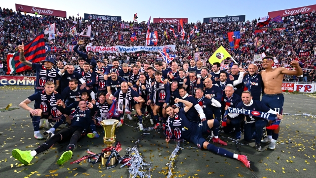 Bologna players celebrating with the Coppa Italia trophy