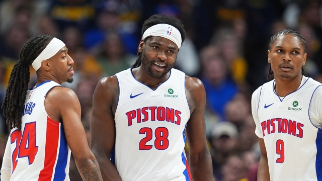 Detroit Pistons center Isaiah Stewart (28) is congratulated after scoring a basket and drawing a foul by guards Daniss Jenkins, left, and Ausar Thompson in the second half of an NBA basketball game against the Denver Nuggets Tuesday, Jan. 27, 2026, in Denver. (AP Photo/David Zalubowski)