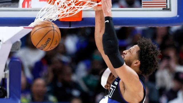 Detroit Pistons guard Cade Cunningham (2) dunks the ball against the Memphis Grizzlies during the first half of an NBA basketball game Friday, March 13, 2026, in Detroit. (AP Photo/Duane Burleson)