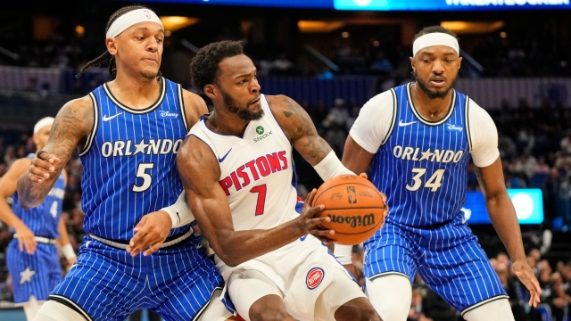 Detroit Pistons forward Paul Reed (7) looks to pass the ball as he gets caught between Orlando Magic forward Paolo Banchero (5) and center Wendell Carter Jr. (34) during the first half of an NBA basketball game, Monday, April 6, 2026, in Orlando, Fla. (AP Photo/John Raoux)