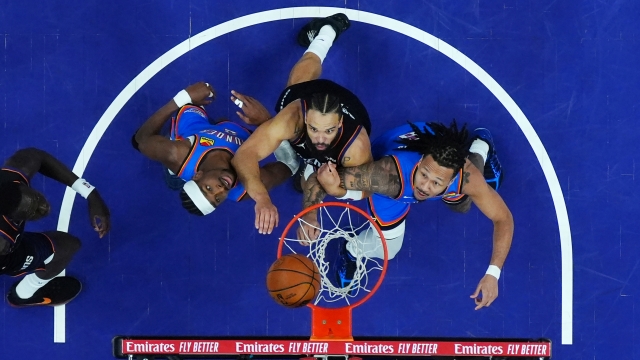 Phoenix Suns center Khaman Maluach, left, Oklahoma City Thunder guard Shai Gilgeous-Alexander, second from left, Suns forward Dillon Brooks, second from right, and Thunder forward Jaylin Williams watch the ball fall through the hoop during the second half of Game 4 in a first-round NBA playoffs basketball series, Monday, April 27, 2026, in Phoenix. (AP Photo/Ross D. Franklin)