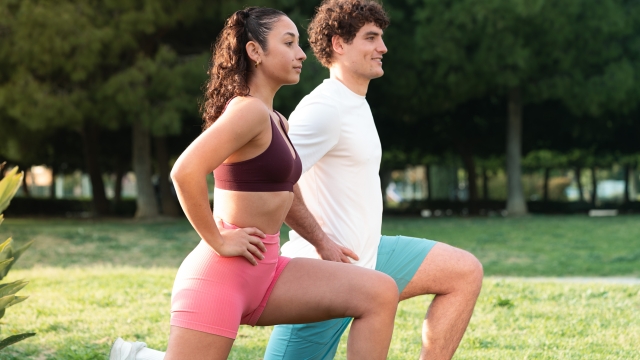 Young man and woman performing lunges during an outdoor fitness workout, focusing on health, wellness, and exercise
