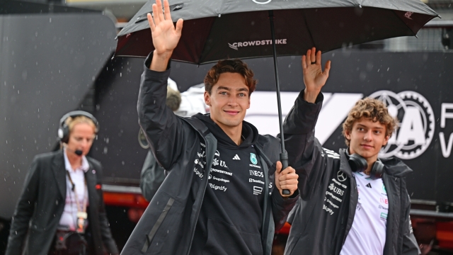 George Russell and Andrea Kimi Antonelli of the Mercedes-AMG Petronas F1 Team walk during race day at the 13th round of the Formula 1 World Championship at Silverstone Circuit in Silverstone, Northamptonshire, England, on July 6, 2025. (Photo by Andrea Diodato/NurPhoto via Getty Images)