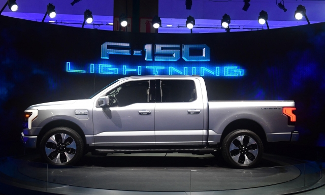 (FILES) In this file photo taken on November 18, 2021, the all-electric F-150 Lightning from Ford is displayed at the Los Angeles Auto Show in Los Angeles. - Ford announced on March 2, 2022, it is creating separate businesses for its conventional and electric-auto operations, as it accelerates its build-out of emission-free vehicles. The conventional internal combustion operations will be known as "Ford Blue," while the electric vehicle (EV) products will be run through "Ford Model e." (Photo by Frederic J. BROWN / AFP)