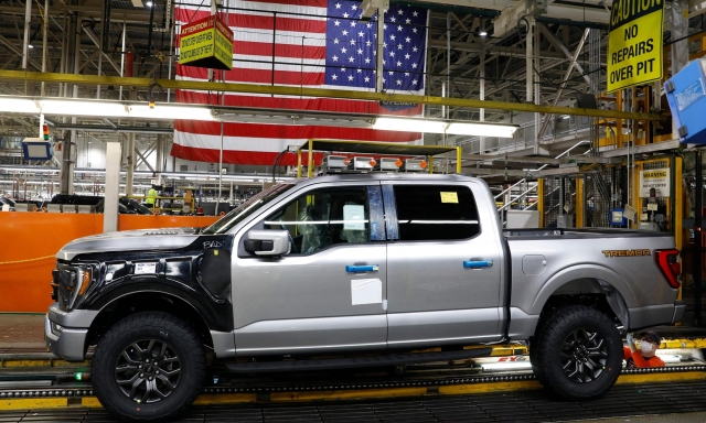 (FILES) In this file photo taken on January 26, 2022, the 40 millionth Ford Motor Co. F-Series truck sits on the assembly line at the Ford Dearborn Truck Plant in Dearborn, Michigan. - Ford plans to suspend production of vehicles including the Ford Bronco, the popular F-150 pickup and the new Mustang Mach-E electric vehicle at its plants in Michigan, Illinois and Mexico, according to outlets including CNBC. (Photo by JEFF KOWALSKY / AFP)