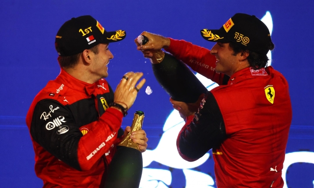 BAHRAIN, BAHRAIN - MARCH 20: Race winner Charles Leclerc of Monaco and Ferrari and Second placed Carlos Sainz of Spain and Ferrari celebrate on the podium during the F1 Grand Prix of Bahrain at Bahrain International Circuit on March 20, 2022 in Bahrain, Bahrain. (Photo by Lars Baron/Getty Images)