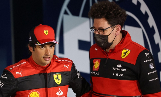Second placed Ferrari's Spanish driver Carlos Sainz Jr (L) talks with Ferrari team principal Mattia Binotto after the Bahrain Formula One Grand Prix at the Bahrain International Circuit in the city of Sakhir on March 20, 2022. (Photo by Giuseppe CACACE / AFP)